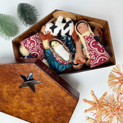 Wooden nativity set with star design on a white background