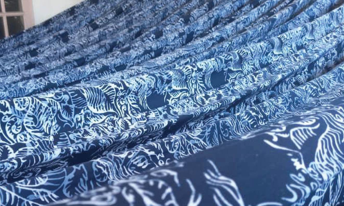 Skilled batik artisans carefully crafting traditional patterns using time-honored techniques.
