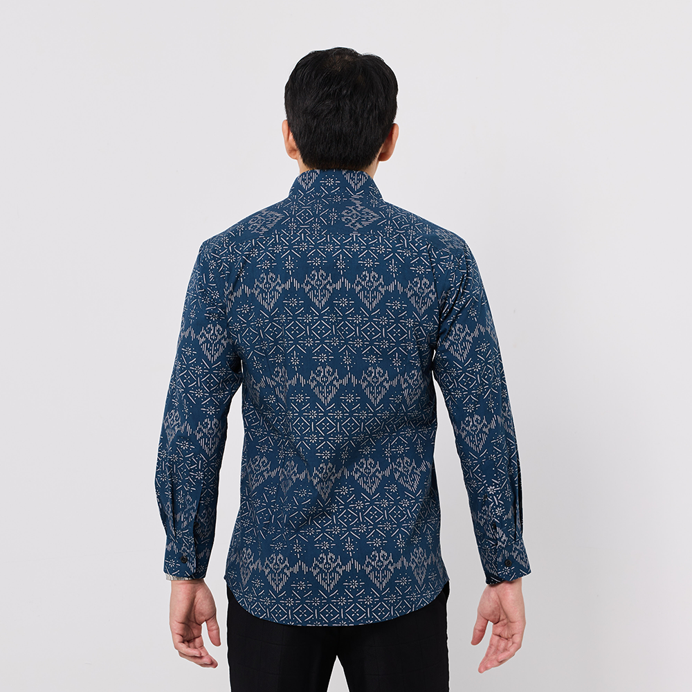 Man wearing a blue patterned shirt on a white background