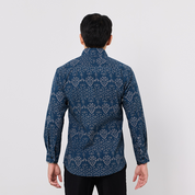 Man wearing a blue patterned shirt on a white background
