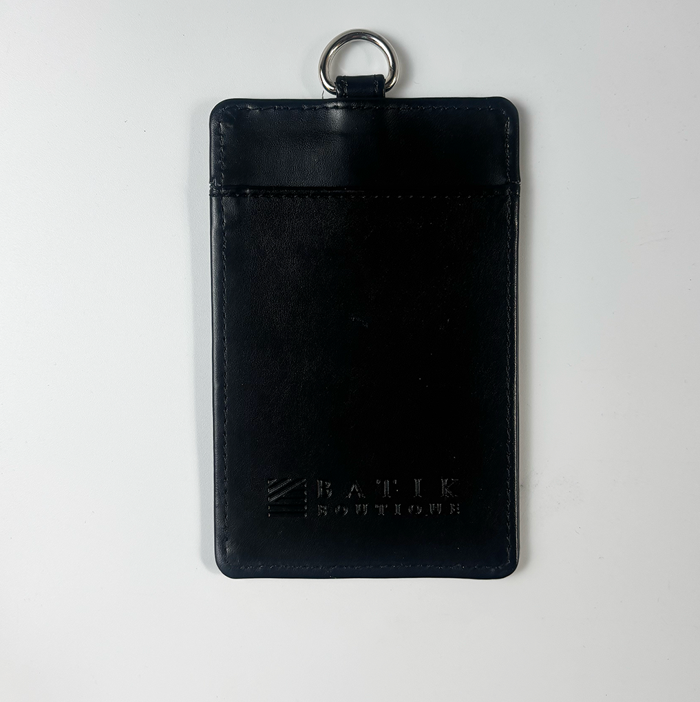 Black leather cardholder with key ring on a light gray background
