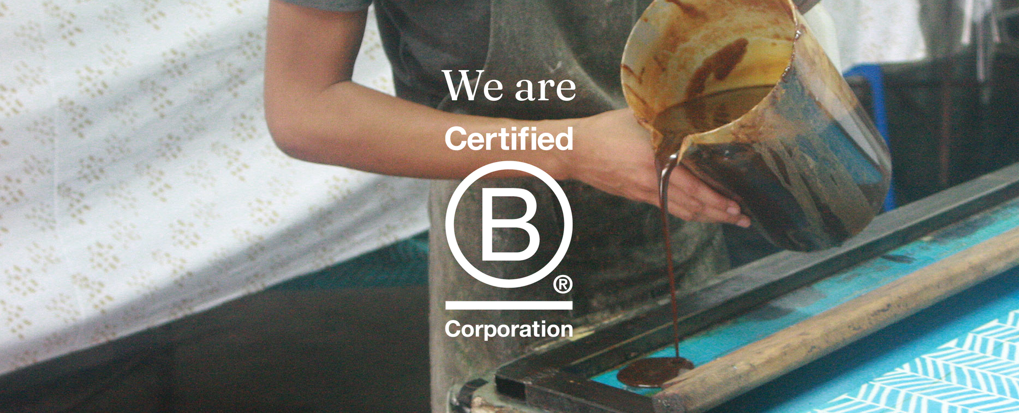 B Corp Banner with man making batik as the backdrop