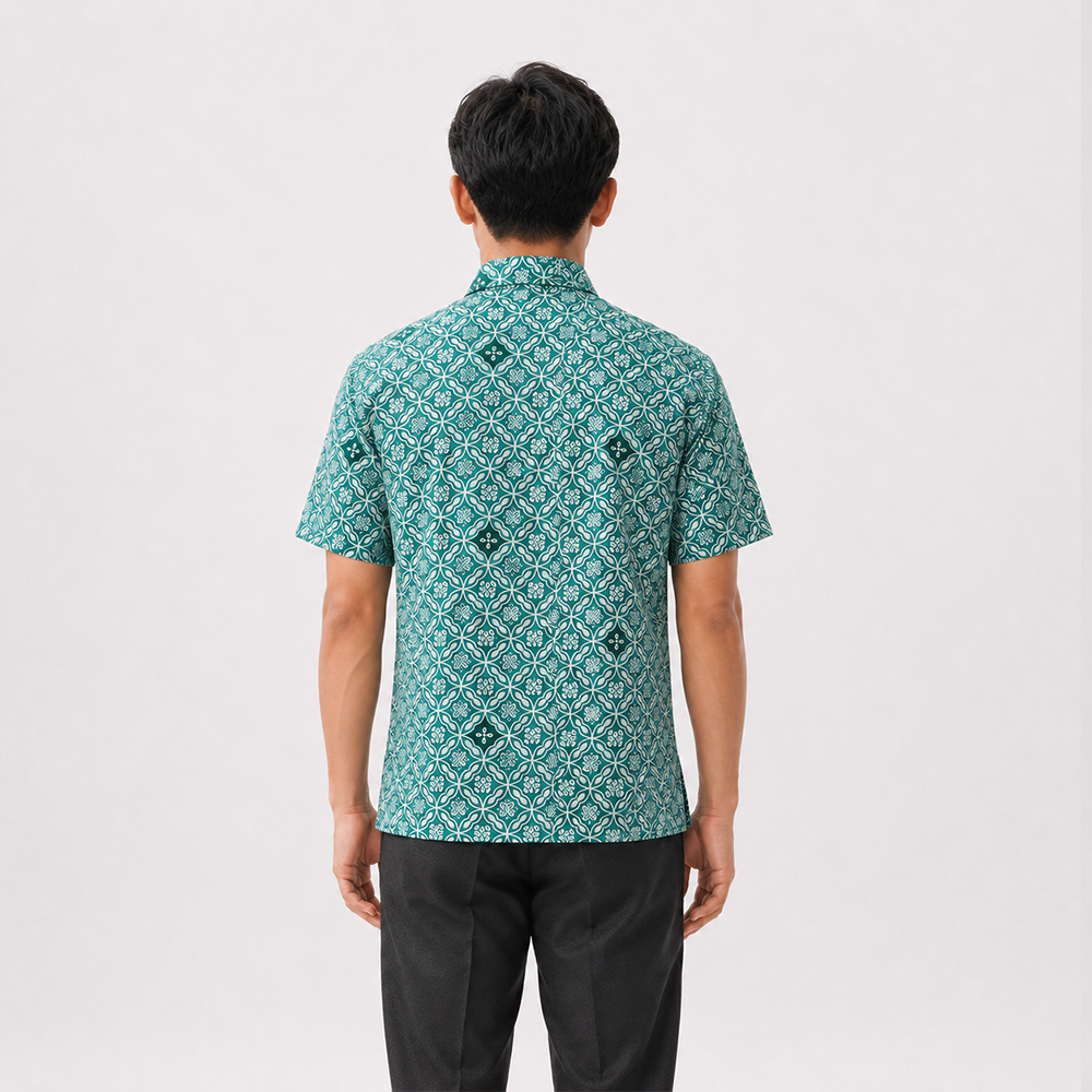 Person wearing a green patterned shirt on a white background