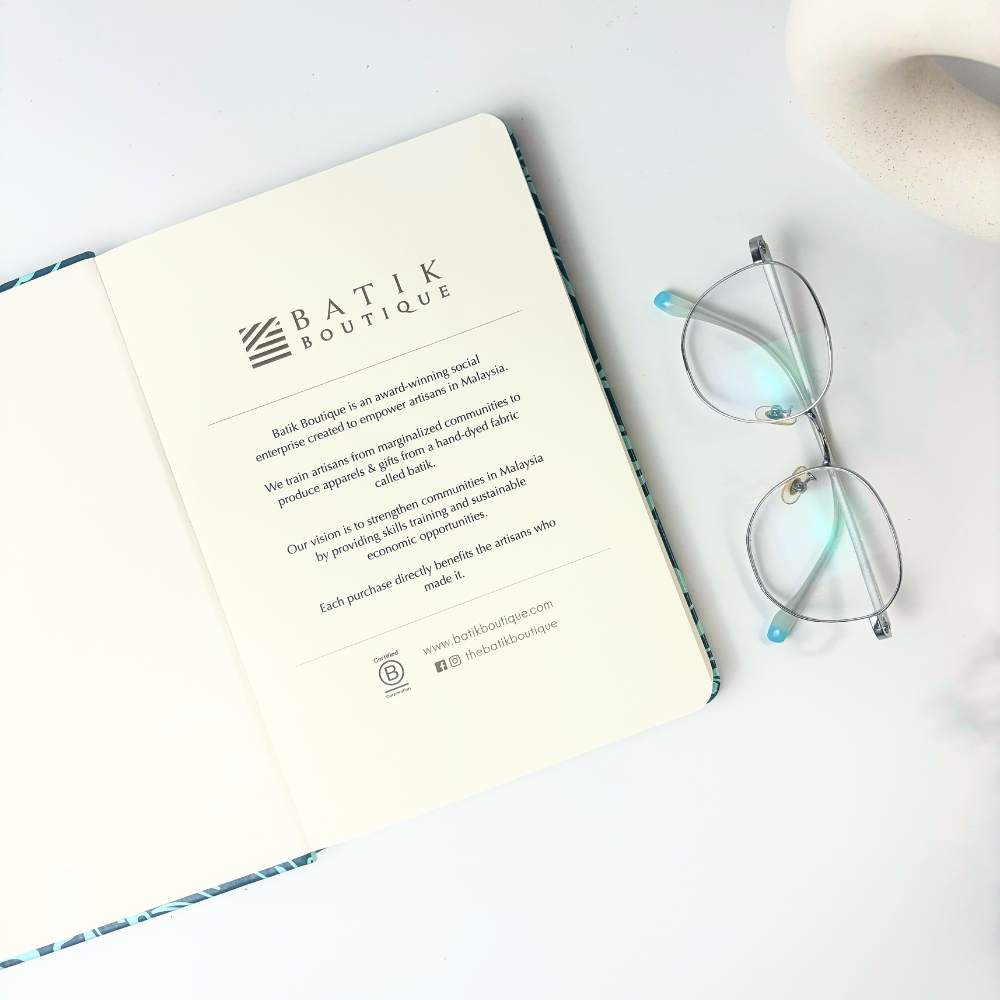 Batik-Inspired Notebook & Pen in Teal Ukir opened to show th first page 