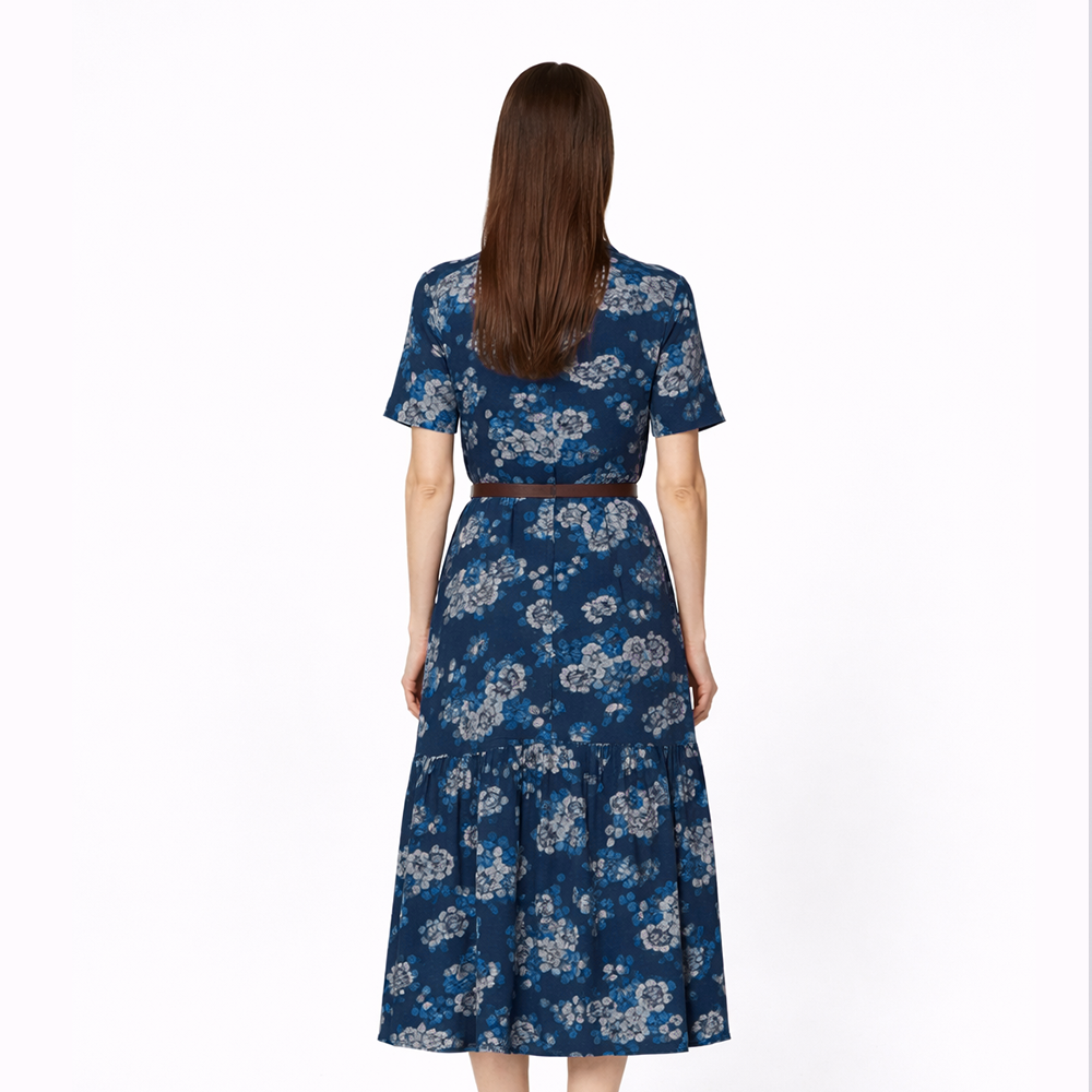 Woman wearing a blue floral dress on a white background