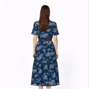 Woman wearing a blue floral dress on a white background