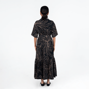 Back view of Batik Boutique’s Onyx Palma Button-Up Dress highlighting the batik motif and flowy A-line cut
