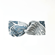 Blue and gray patterned bow tie on a white background