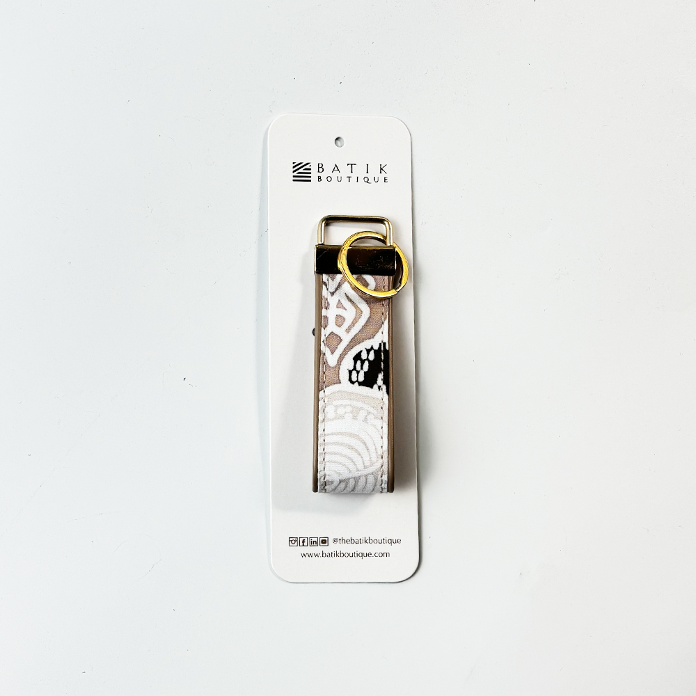 Keychain with lace design on a white background, featuring the Batik Boutique brand.