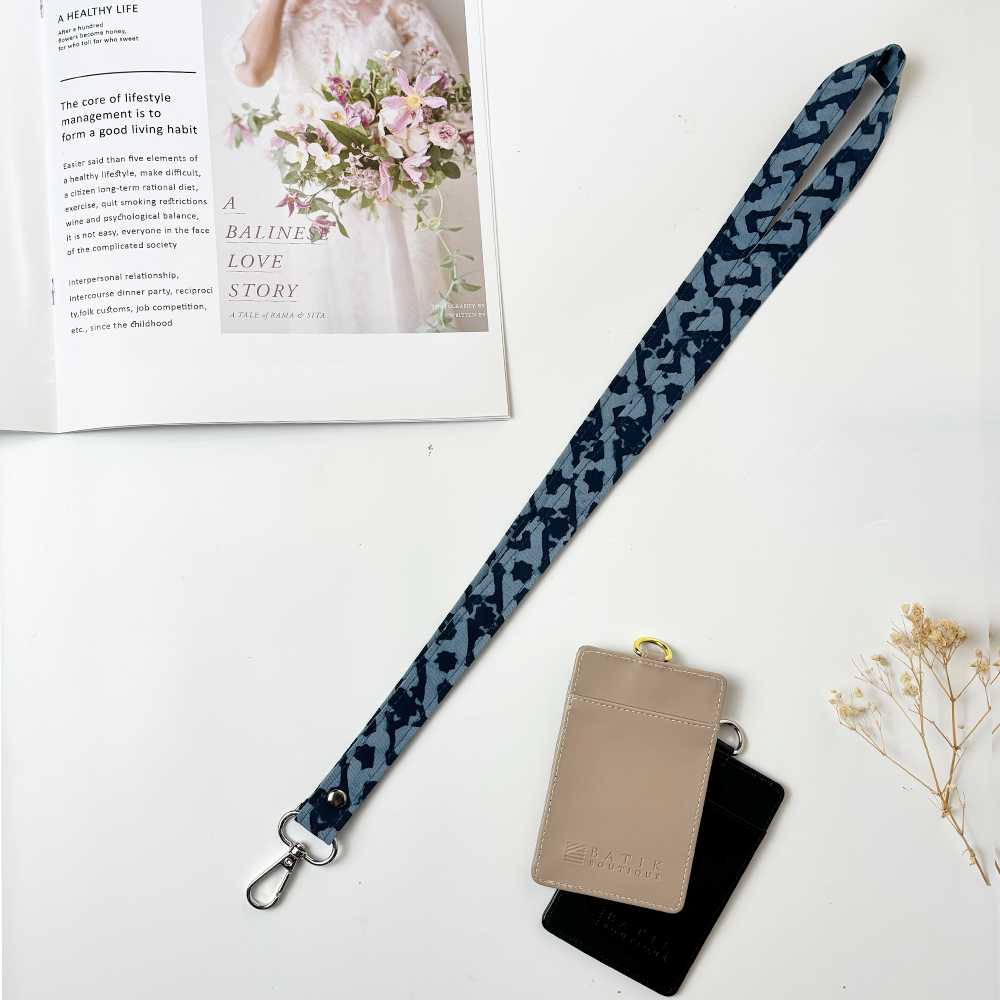 Batik Lanyard - Midnight Arabesque shows laid flat in a lifestyle photo