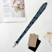 Batik Lanyard - Midnight Arabesque shows laid flat in a lifestyle photo
