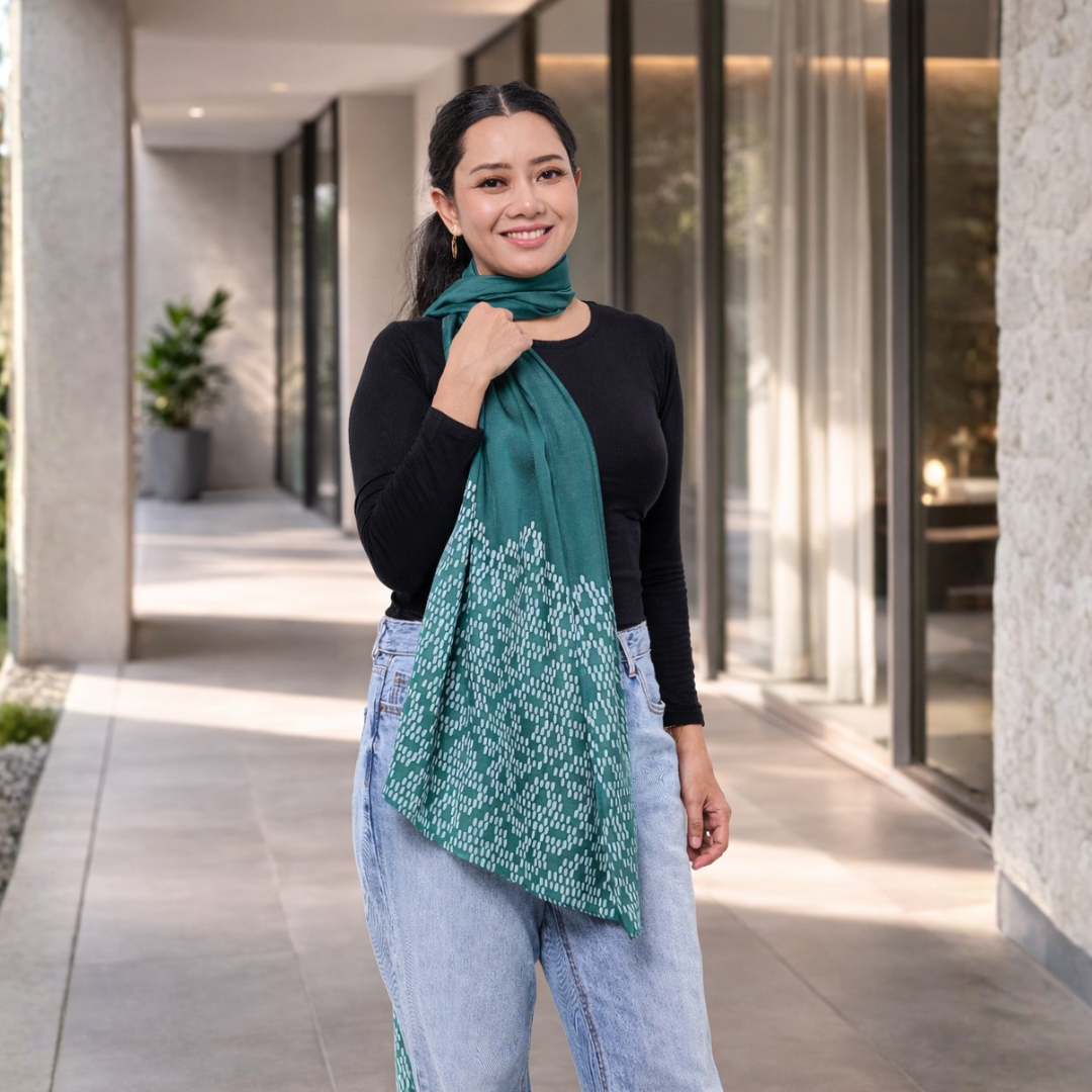 Woman wearing a green scarf in an outdoor setting