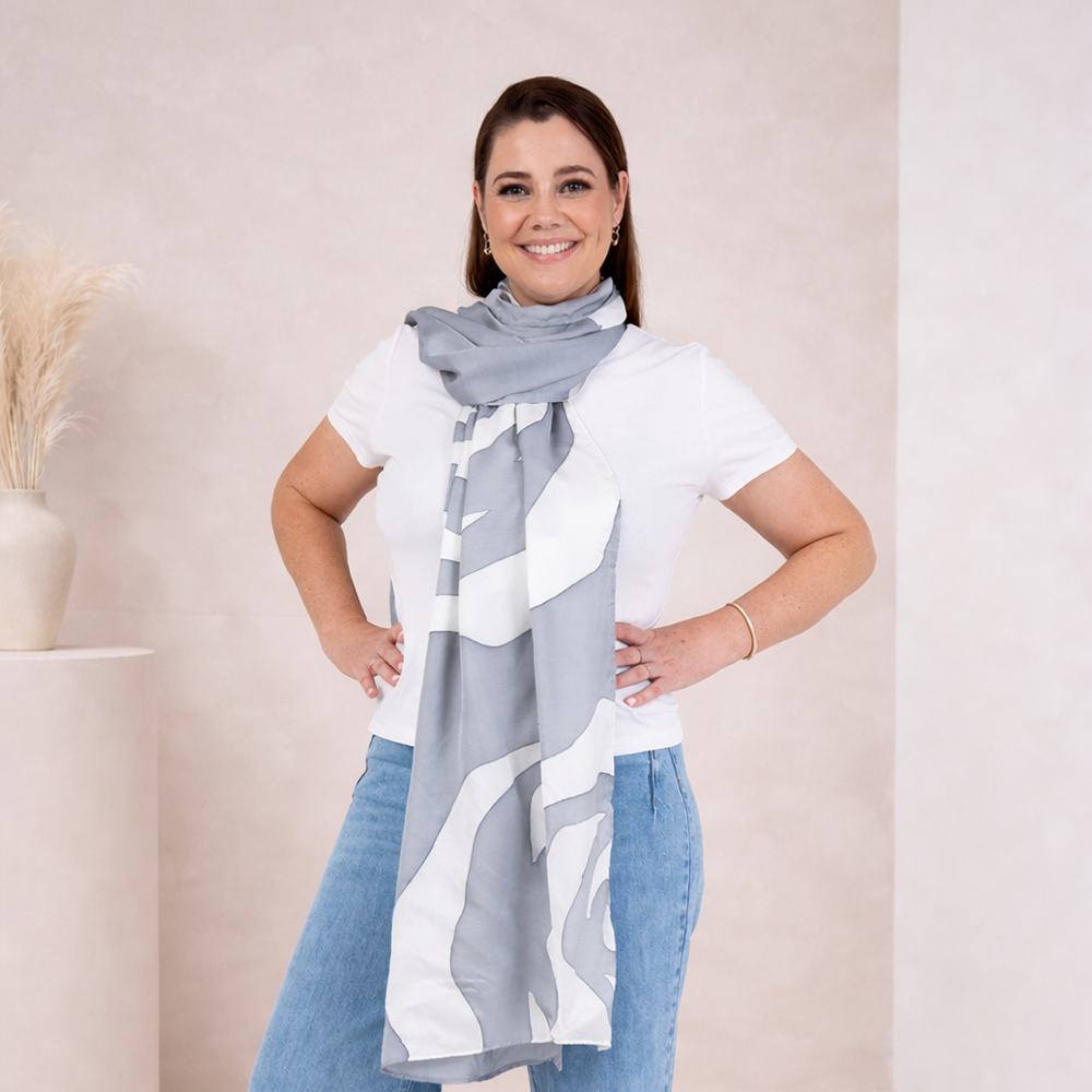 Woman wearing a large gray and white patterned scarf