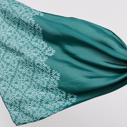 Teal fabric with a subtle pattern on a light gray background