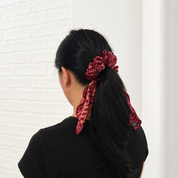 Lady wearing Red/Copper Batik Scrunchy