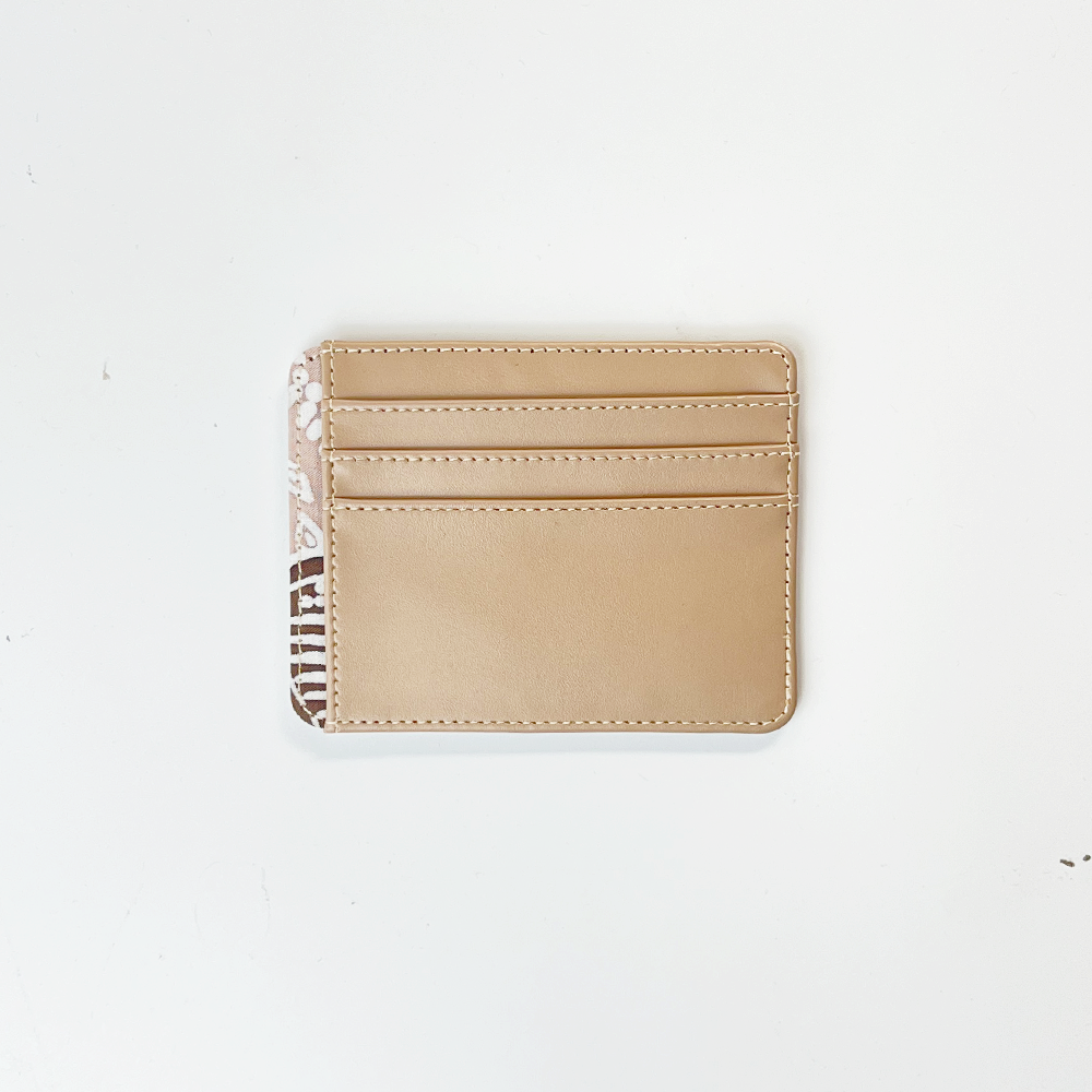 Beige cardholder with zebra pattern strap on a white background