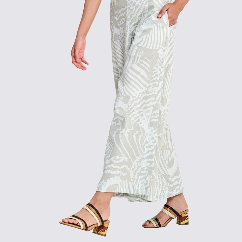 Woman wearing grey printed batik wide leg trousers walking
