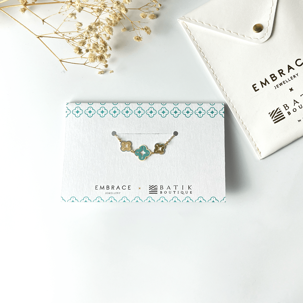 Jewelry card with a necklace design on a white surface with 'Embrace Batik Boutique' branding.