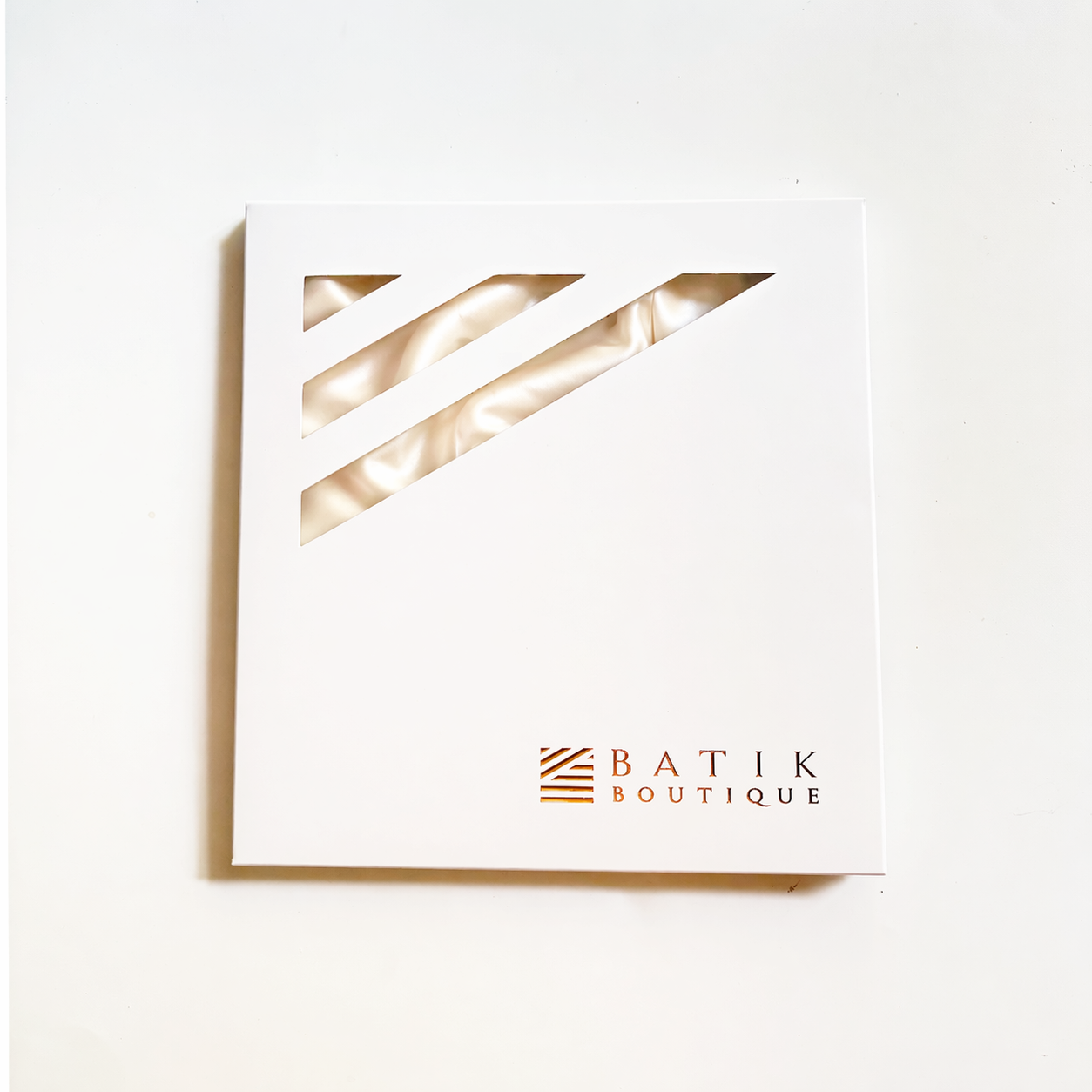 Framed artwork with geometric design and 'Batik Boutique' logo on a white background