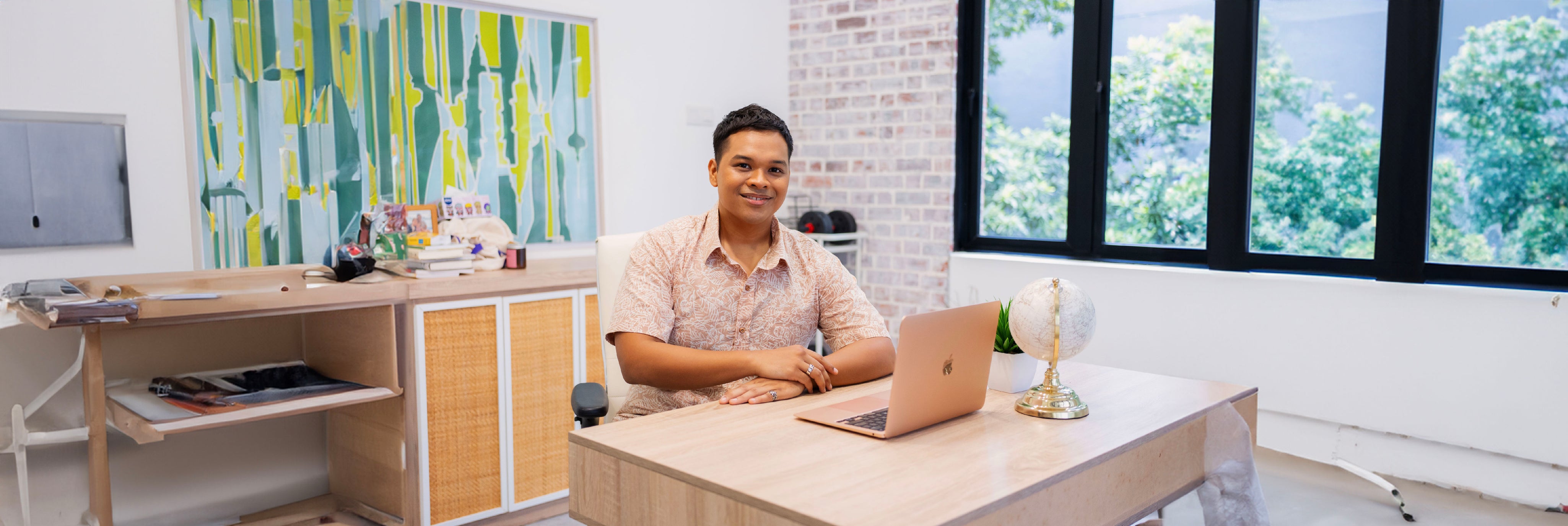 Man wearing batik apparel in an office