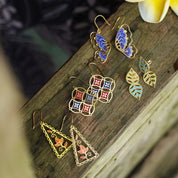 Set of colorful earrings on a wooden surface