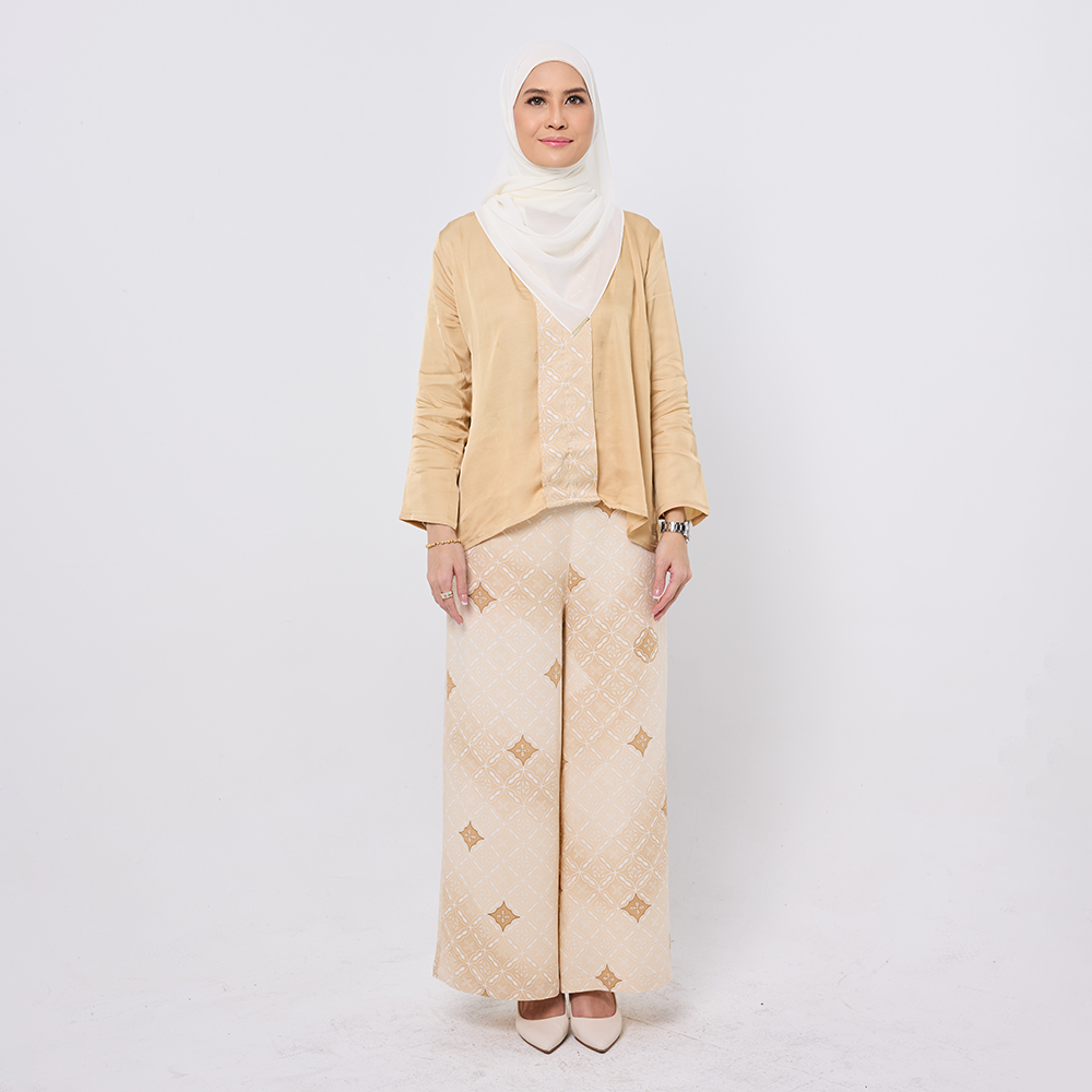 Woman wearing a beige outfit with a hijab on a white background