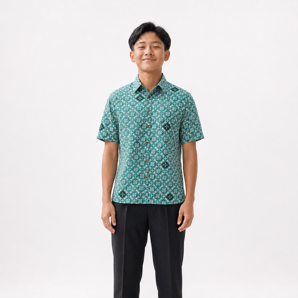 Person wearing a patterned teal shirt on a white background