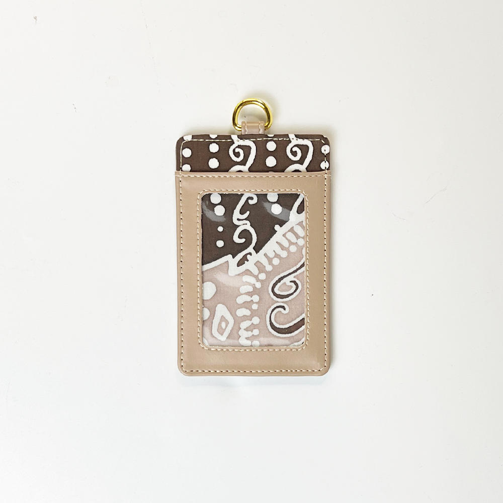Beige card holder with brown and white pattern on a white background