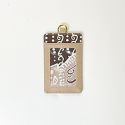 Beige card holder with brown and white pattern on a white background