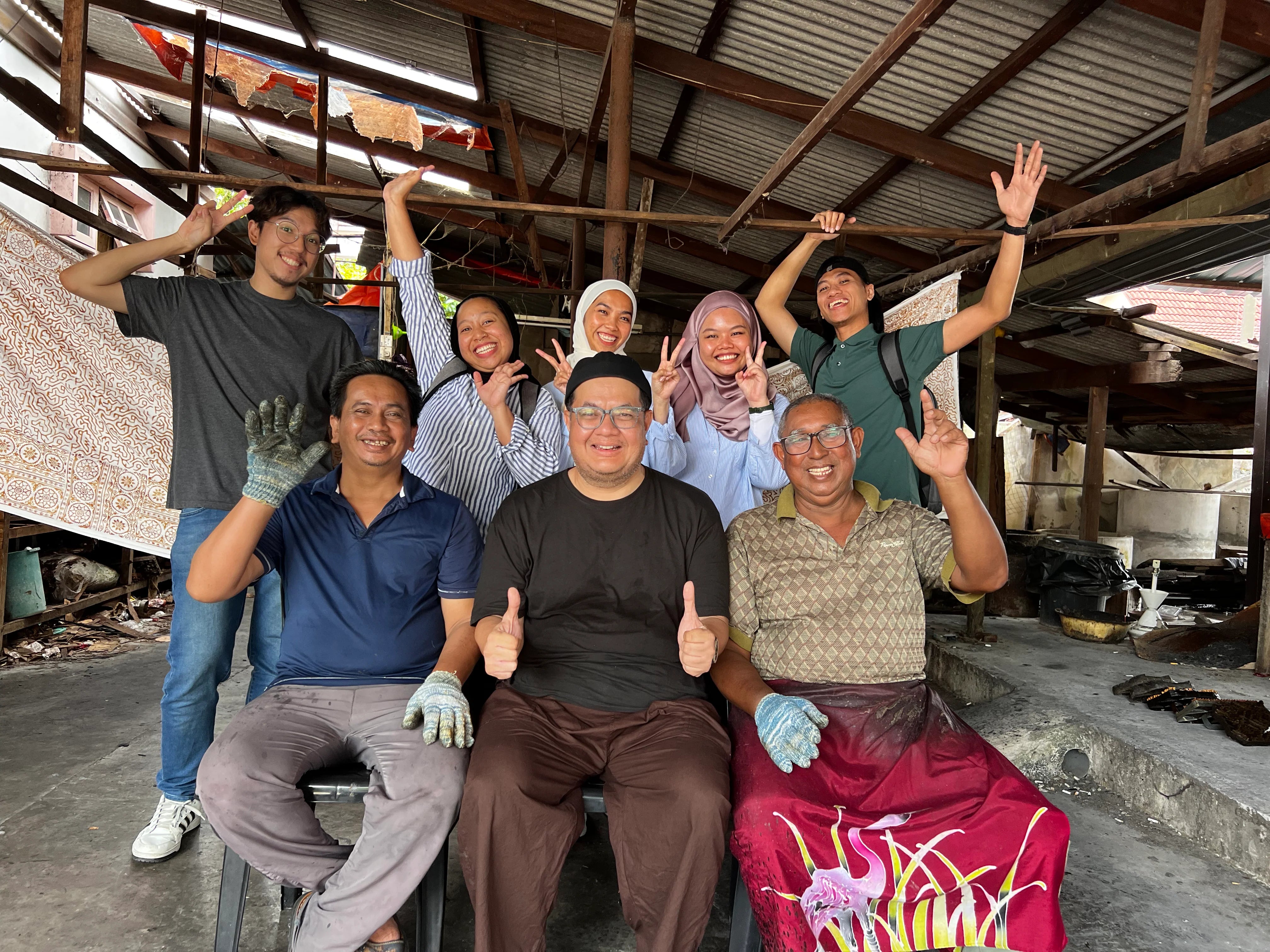 Skilled artisans creating authentic batik designs using traditional techniques.