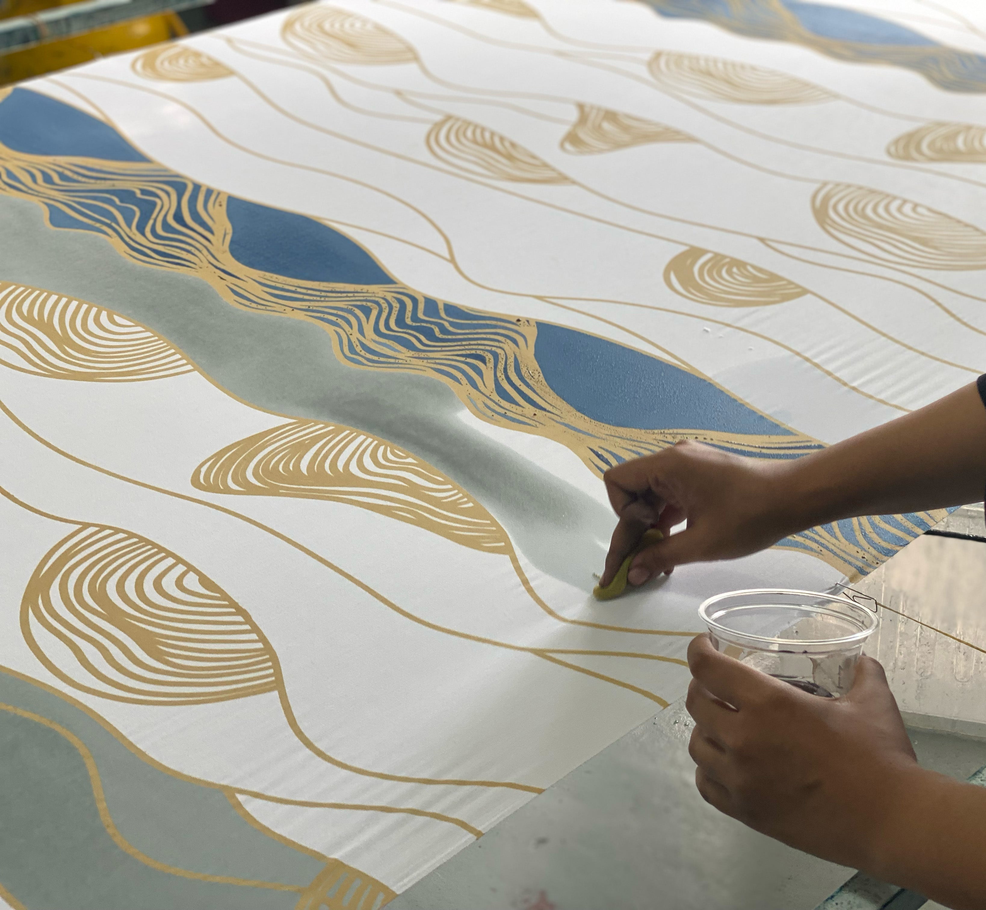 Skilled artisans creating authentic batik designs using traditional techniques.