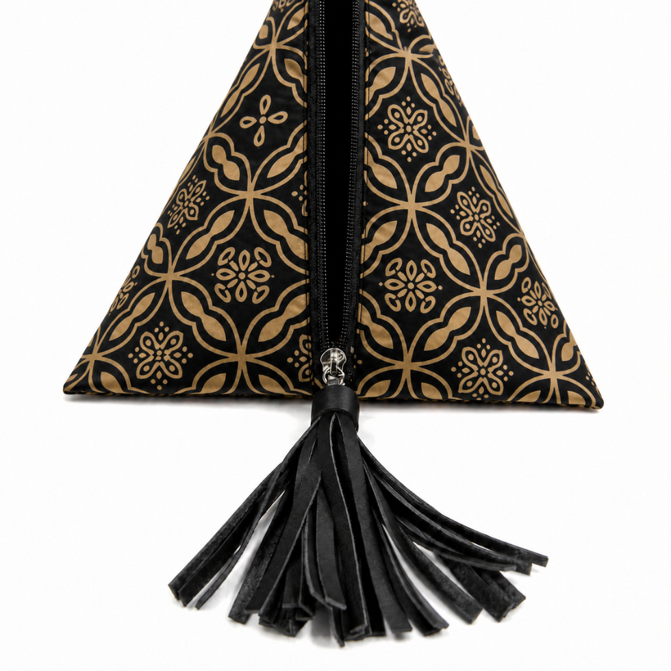 A black and gold patterned triangular clutch bag with a black leather tassel zipper pull, shown against a plain white background.