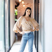 Model wearing the lifestyle tan orchid tie up kimono paired with a set of jeans 