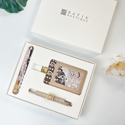 Set of travel accessories including a card holder, strap, and lanyard in a Batik Boutique box.