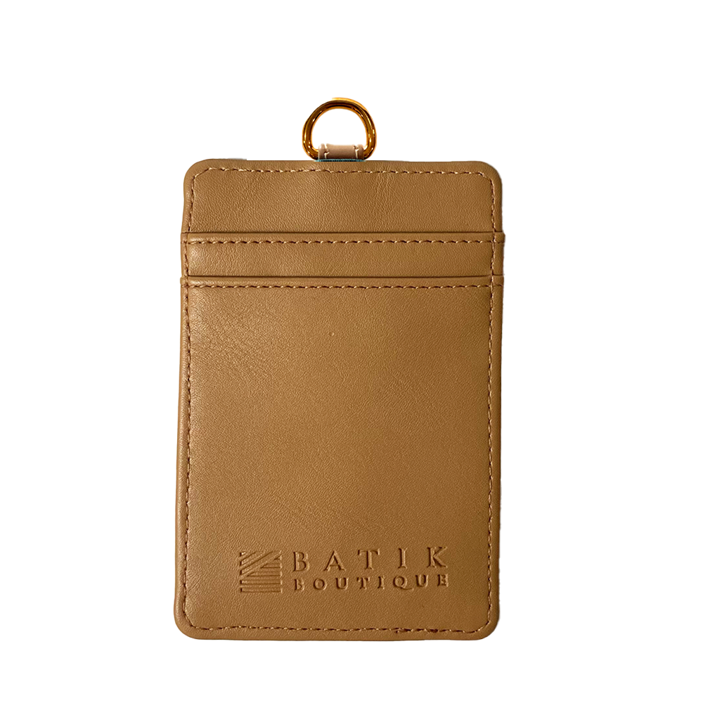 Brown leather cardholder with gold ring on a white background