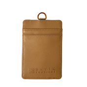 Brown leather cardholder with gold ring on a white background