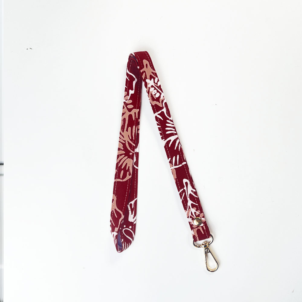 Red and white patterned lanyard on a white background