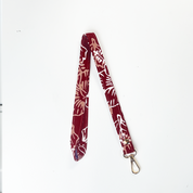 Red and white patterned lanyard on a white background