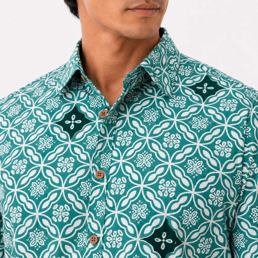 Man wearing a green patterned shirt with white floral design