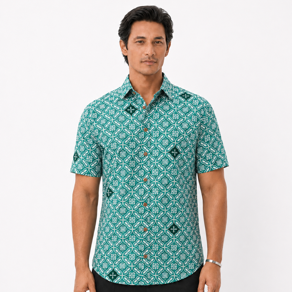 Man wearing a green patterned shirt on a white background