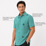 Man wearing a green patterned shirt on a white background