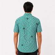 Person wearing a green patterned shirt on a white background