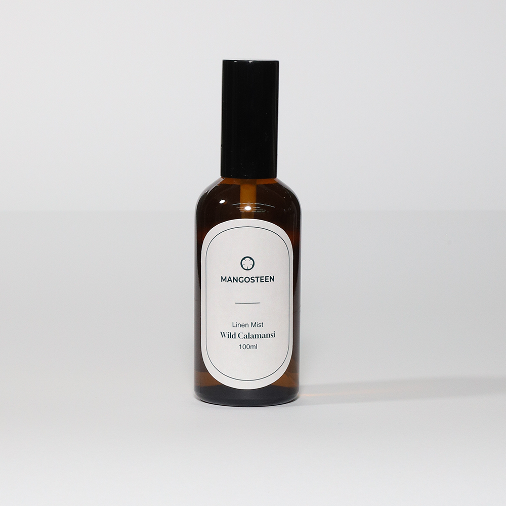 A bottle of 'Mangosteen' Linen Mist with a label that reads '100ml' and 'White Calamansi'.