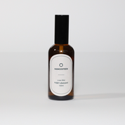 A bottle of 'Mangosteen' Linen Mist with a label that reads '100ml' and 'White Calamansi'.