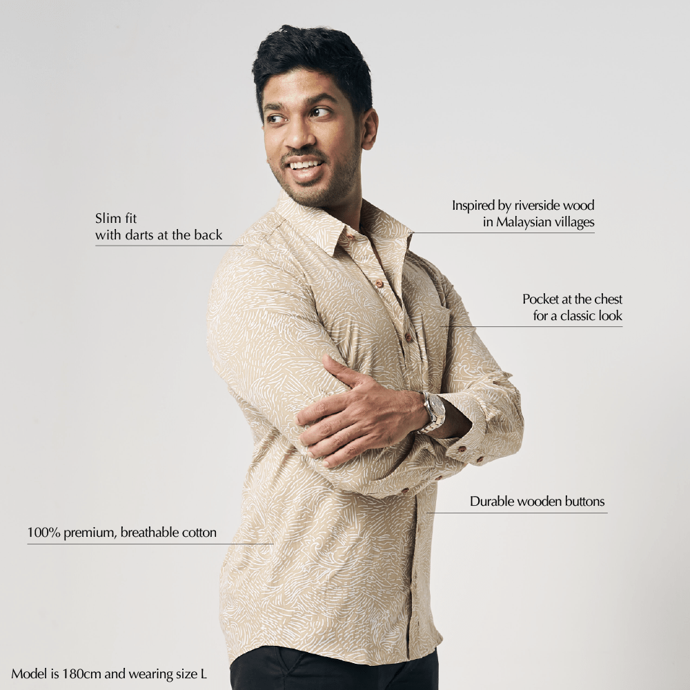 Man wearing a beige shirt with text describing its features on a light gray background