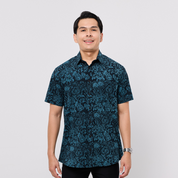 Man wearing a blue patterned shirt on a white background
