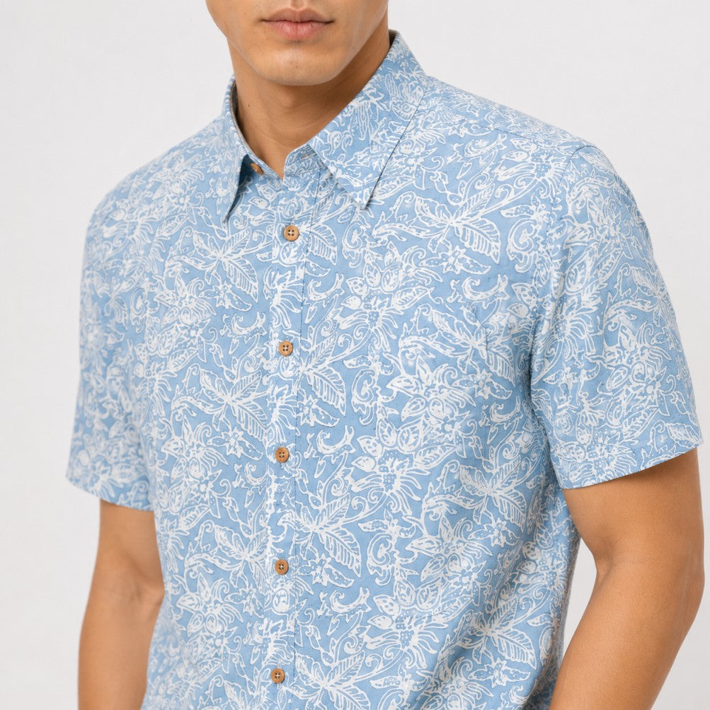 Man wearing a blue patterned shirt on a white background