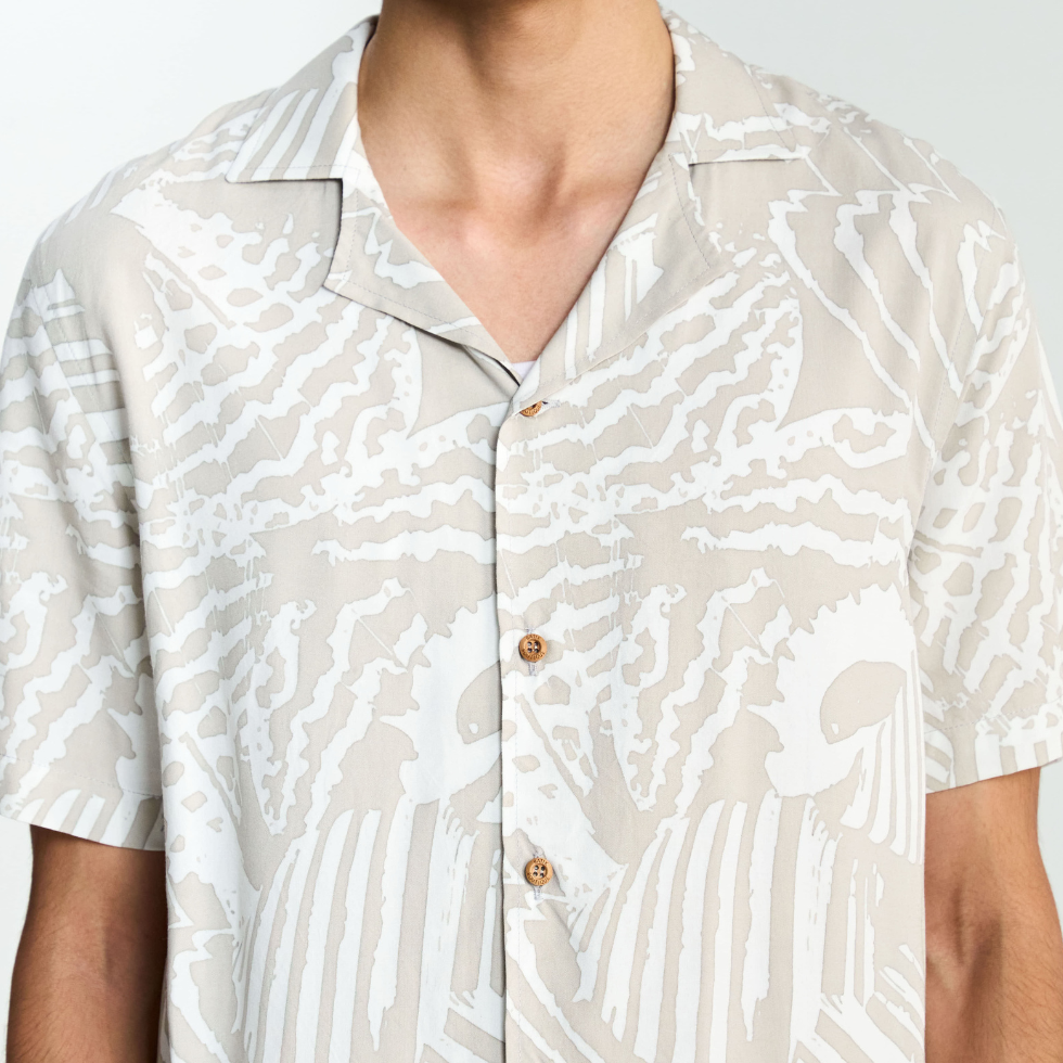 Closeup showing details of the grey batik shirt