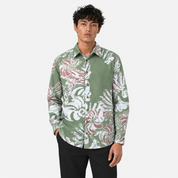 Man wearing a patterned shirt on a light gray background