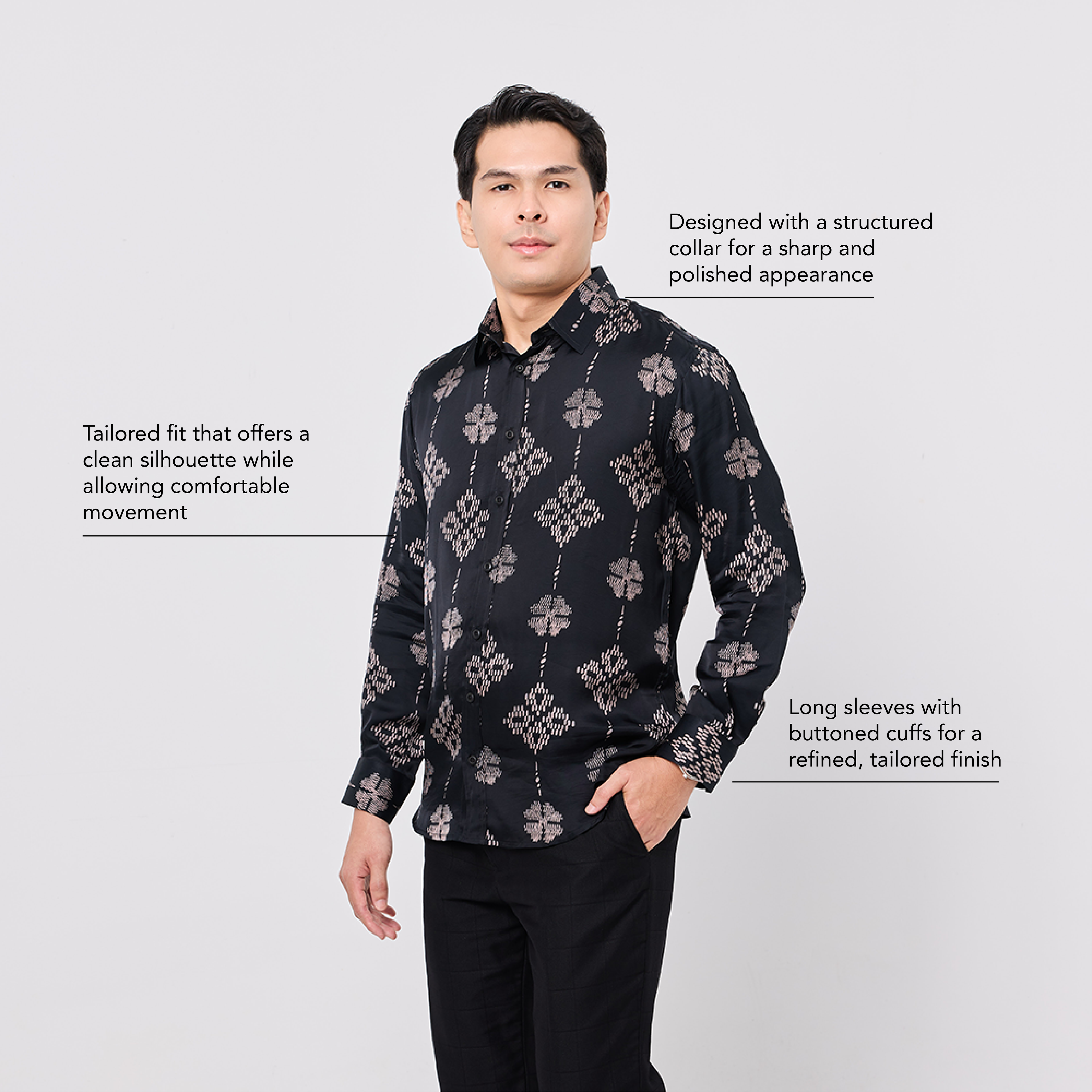 Man wearing a black patterned shirt with text on a light gray background
